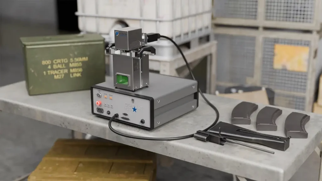Laser marking machine with a military ammunition box and magazines, showcasing advanced laser technology for marking and welding military equipment.